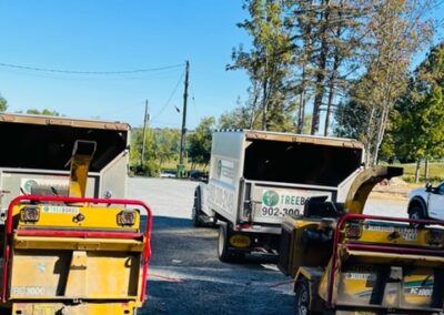 Wood chippers parked on gravel lot.